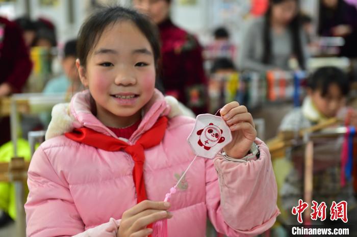 圖為一名小學(xué)生繡制的2022年北京冬奧會(huì)吉祥物“冰墩墩”形象?！∮髟屏?攝