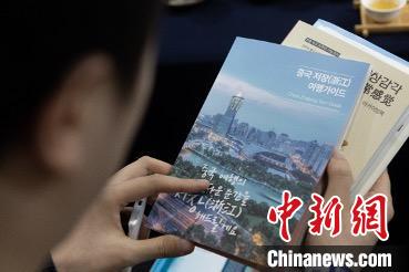 參展觀眾閱讀浙江文旅手冊(cè)?！《≌裾?攝