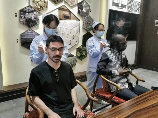 2023“一帶一路”媒體合作論壇聯(lián)合采訪團(tuán)團(tuán)員在九牛草展示館體驗(yàn)艾灸。（本報(bào)記者 黃超攝）