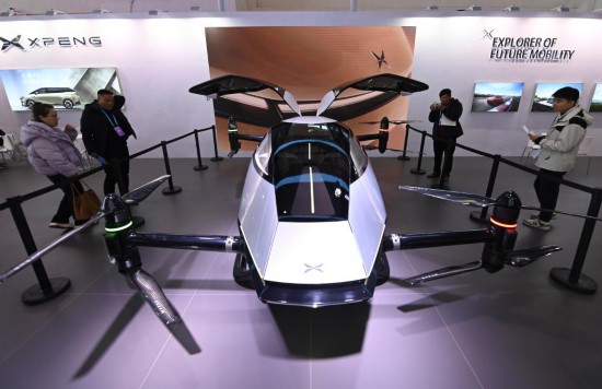 2023年12月1日，在鏈博會(huì)智能汽車鏈展區(qū)小鵬汽車展臺(tái)，參觀者觀看一臺(tái)智能飛行器。新華社記者蔡湘鑫攝