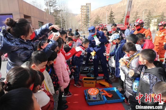 圖為小朋友們聽消防員講解消防器材?！铨埥?攝
