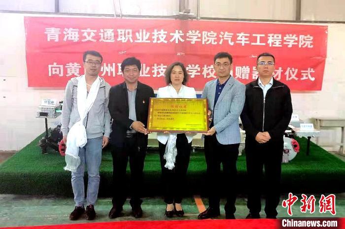 圖為李富香(中)代表學(xué)校為州縣技校捐贈(zèng)器材。(資料圖) 青海省教育廳供圖