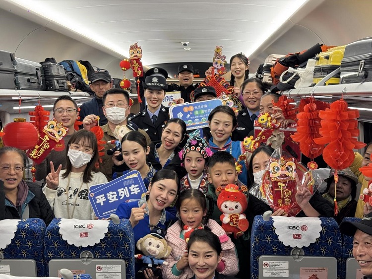 春節(jié)期間，在中老鐵路磨萬（磨丁—萬象）段，鐵路客運員工與乘客合影留念。李加勇攝
