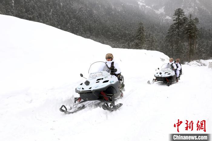 圖為雪地摩托車開路。　薛金博 攝