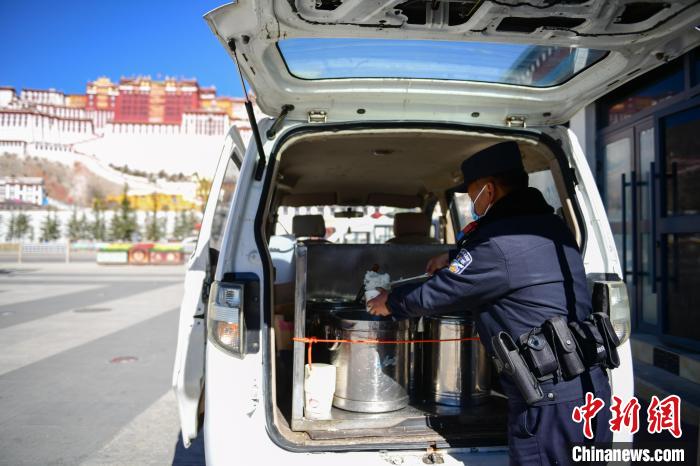 圖為1月23日，布達(dá)拉宮廣場(chǎng)派出所民警正在打午飯?！∝暩聛硭?攝