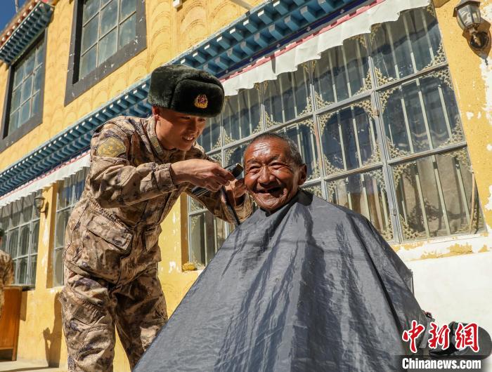 圖為阿里軍分區(qū)某邊防團官兵為駐地群眾理發(fā)迎藏歷新年?！〉┰鰝愔?攝
